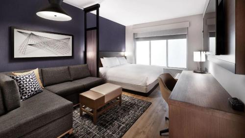 a living room with a couch and a bed at Hyatt Place Boise-Meridian in Meridian