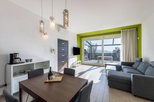 a living room with a table and a couch at Residence Virgilio Green in Toscolano Maderno