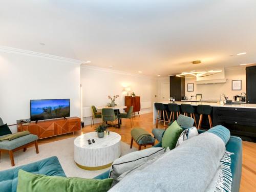 a living room with a couch and a table at Pass the Keys Beautiful 2 Bed Apartment with Parking in the Bay in Cardiff