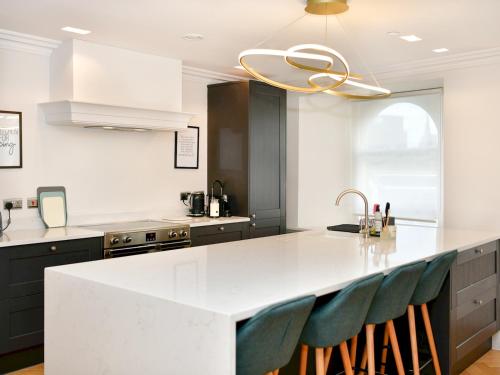 a kitchen with a white counter top and a sink at Pass the Keys Beautiful 2 Bed Apartment with Parking in the Bay in Cardiff
