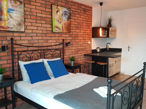 a bedroom with a bed and a brick wall at NORTH in Jastrzębia Góra