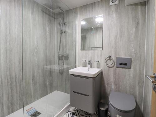 a bathroom with a toilet and a sink and a shower at The Eller Beck in Skipton