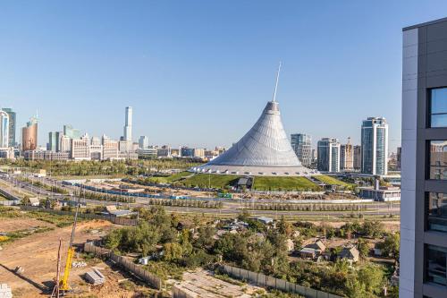 a view of a large building with a city in the background at RAISSON APARTHOTEL T91 Хан Шатыр in Astana