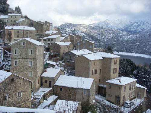 a group of buildings with snow on their roofs at Côté Lac Tolla in Tolla