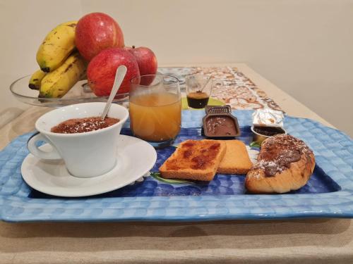 a tray of breakfast foods and a cup of coffee at Sicilia Mount&Sea in Mascali