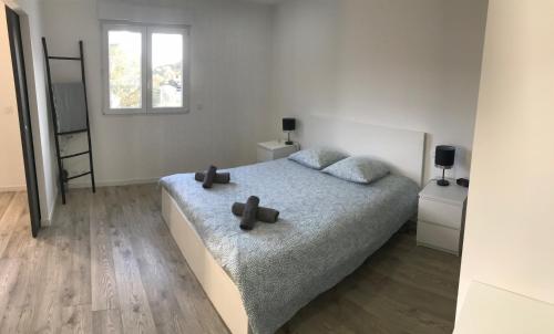 a bedroom with a bed with two crosses on it at "LES ALIZES" Côté PISCINE PROCHE BORD DE MER in Saint-Raphaël