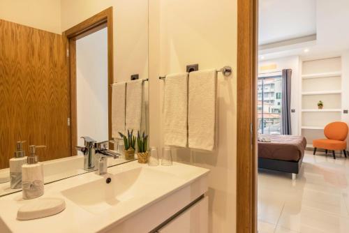 a bathroom with a sink and a mirror at Anadia Atrium F in Funchal