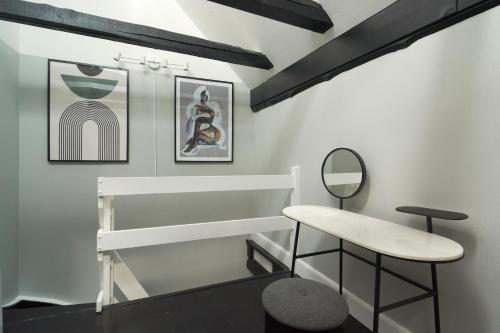 a dressing room with a stool and a mirror at Unique 2 Bedroom Duplex w Exposed Beams in CPH City in Copenhagen