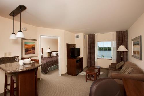 a hotel room with a bedroom and a living room at Staybridge Suites Great Falls, an IHG Hotel in Great Falls