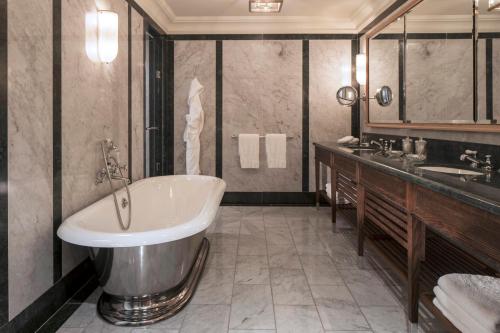a bathroom with a tub and a sink at Four Seasons Hotel Hampshire in Winchfield