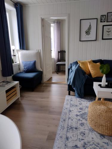 a living room with a couch and a chair at Light home apartment Alesund with free parking in Ålesund