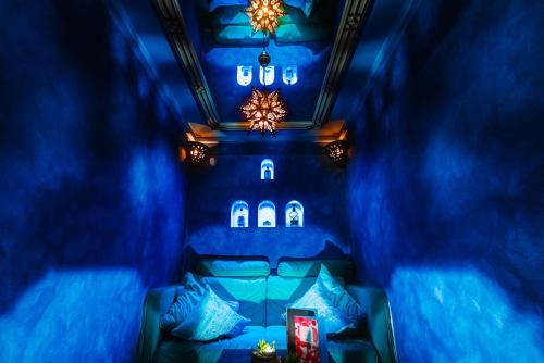 a blue room with a bed with blue lights at Hotel BEI SCHUMANN in Kirschau