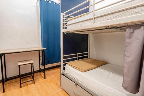 a room with two bunk beds and a table at Casa Barcelo Hostel Barcelona in Barcelona