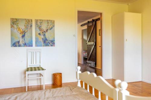 a living room with a chair and a painting on the wall at 3-bedroom condo with indoor fireplace in Nyland