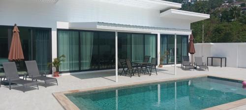 a house with a swimming pool next to a house at kadena villa in Koh Samui 