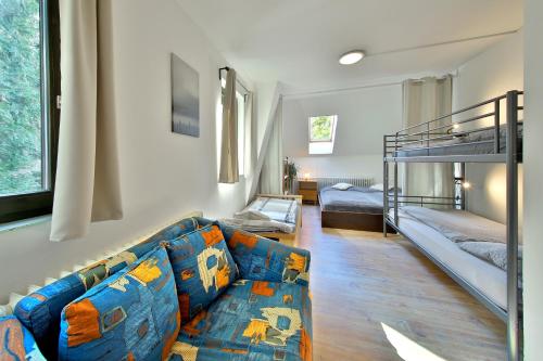 a living room with a couch and a bunk bed at Penzion Kairos in Klokočí
