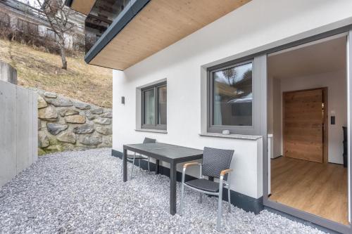 a table and chairs on the patio of a house at Luisalle Top 2 in Auffach