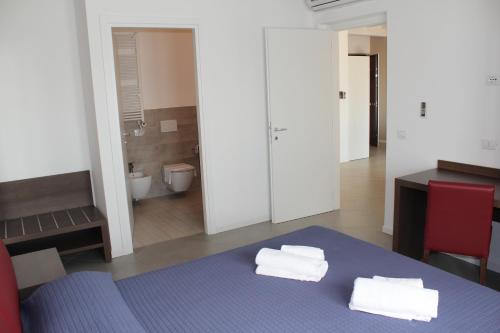 a room with a blue bed with towels on it at Residenza Sante in Lazise