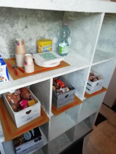 a white shelf with food and other items on it at B&B Porte Rosse in Solferino