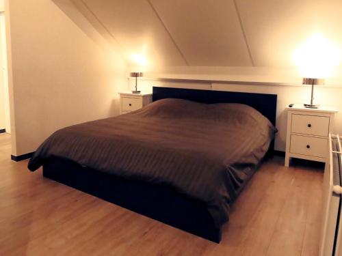a bedroom with a large bed and two night stands at One bedroom apartement with wifi at Waterloo in Waterloo
