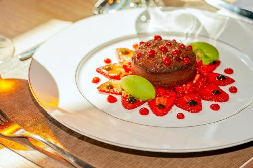 a dessert on a white plate on a table at Best Western Plus Hôtel Le Rhénan & Restaurant Chez Claude in Dorlisheim