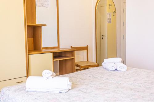 a bedroom with a bed with towels on it at Hotel Continental in Bellaria-Igea Marina