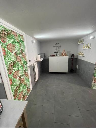 a kitchen with a wall with a mural of flowers at A un passo dal Castello Maschio ANGIOINO Appartment in Naples