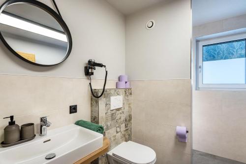 a bathroom with a sink and a mirror at Luisalle Top 4 in Auffach