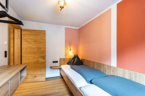 a bedroom with a bed and orange walls at Luisalle Top 4 in Auffach