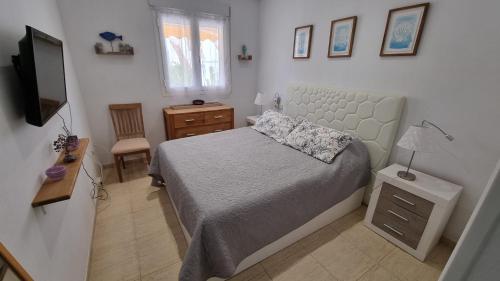 Dormitorio pequeño con cama y TV en casa luxury 2 nudista, en Vera