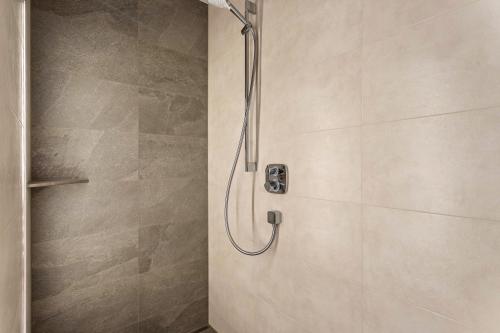 a shower with a shower head in a bathroom at Luisalle Top 6 in Auffach