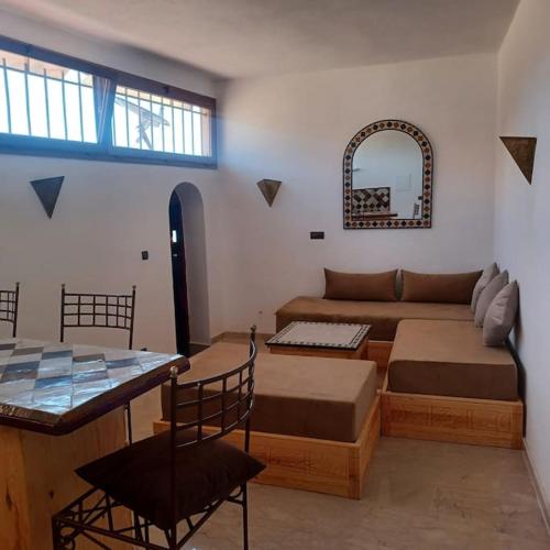a living room with a couch and a table at Balcon sur l'ocean in Taghazout