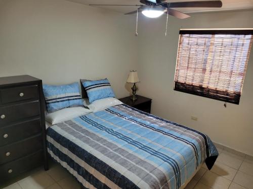 a bedroom with a bed and a ceiling fan at Relaxing Place Near the Sea in Ensenada