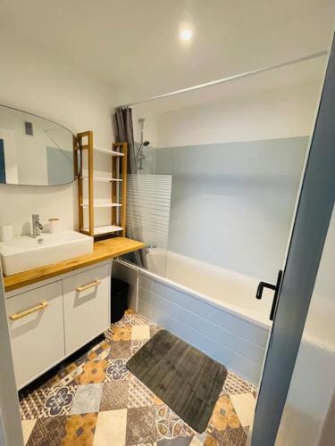 Appartement spacieux et lumineux في سانت بريوك: حمام مع حوض وحوض استحمام