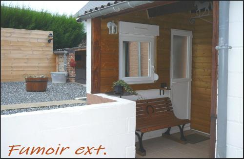 a bench sitting outside of a building with a window at Gîte Onze in Liessies