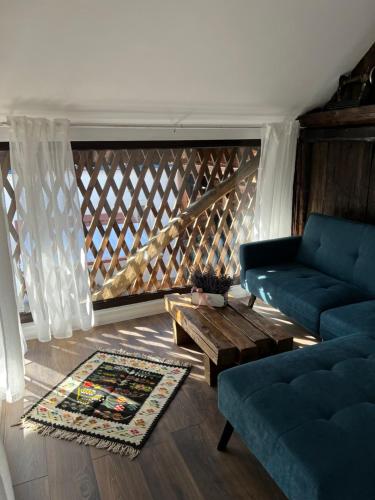 a living room with a couch and a coffee table at Casa de vacanta traditionala La Fanar in Schiuleşti