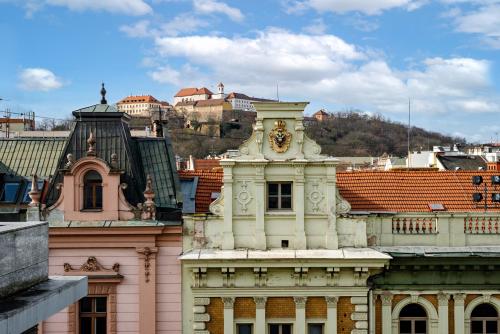 a building with a clock on the top of it at Apartment Brno in Brno