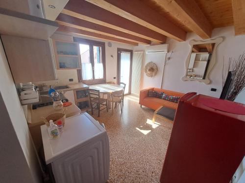 a kitchen and a living room with a couch and a table at A CASA DI BARBARA in Monselice