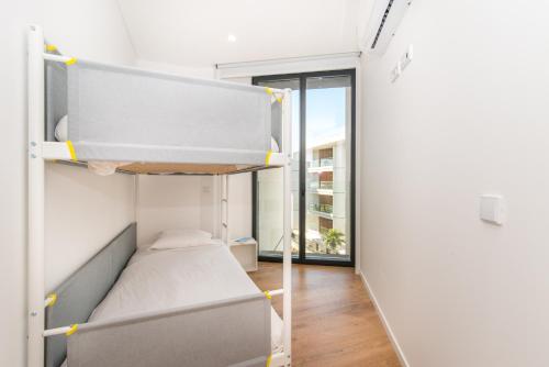 Ένα ή περισσότερα κρεβάτια σε δωμάτιο στο Luxo à Beira-Mar na Ria Formosa