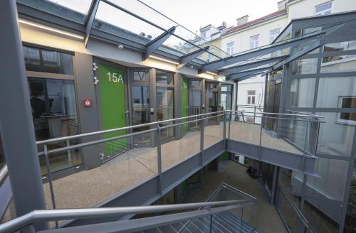 a balcony of a building with a green door at Smart Nano Living - Wien Hauptbahnhof in Vienna