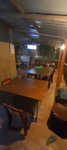 a room with tables and chairs in a restaurant at Sinharaja Vini Villa in Deniyaya