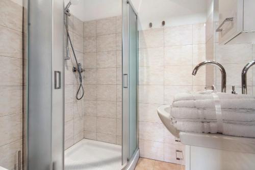 a bathroom with a shower and a sink at Fogazzaro Lake View Apartment in Oria