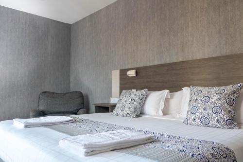 Postel nebo postele na pokoji v ubytování Hotel Kapital