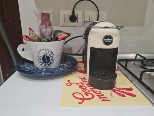 a coffee maker and a cup on a counter at Sicilia Mount&Sea in Mascali