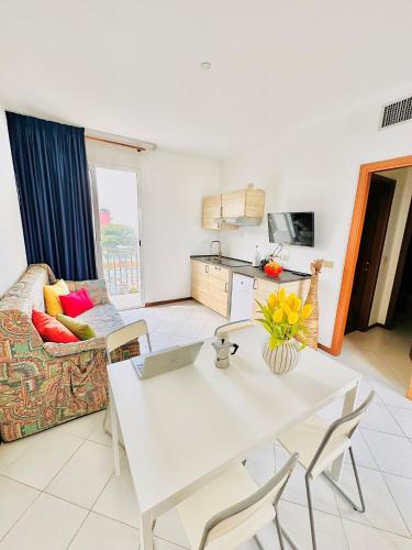 a living room with a white table and a couch at Hotel Rosmary in Lido di Jesolo