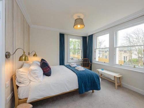 a bedroom with a bed and two windows at Marine House in Gullane