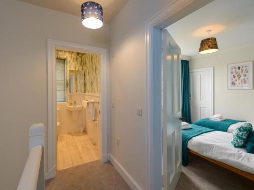 a bedroom with two beds and a bathroom at Marine House in Gullane