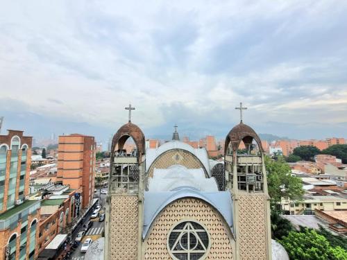 a church with two crosses on top of it at Origen Local Suites in Medellín