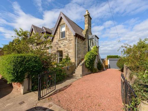 a brick house with a gate and a driveway at Forthview in North Berwick