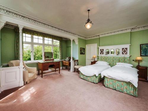 a large bedroom with two beds and a desk at Glenconner House in North Berwick